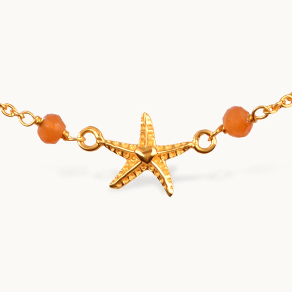Armbånd med lapis, onyx og gyldne søstjerner